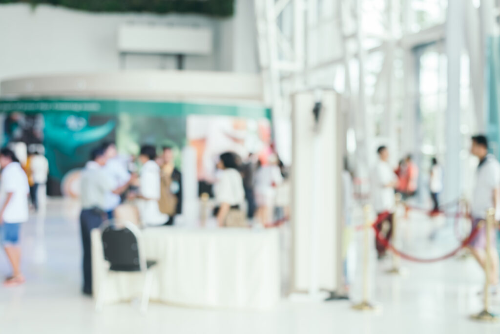 Blurred Background : People Shopping At Market Fair In Sunny Day